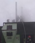 Pięciu strażaków stojących na dachu